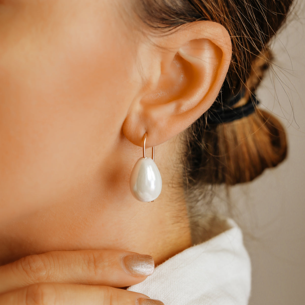 Handmade ceramic pearl teardrop earrings featuring large white pear-shaped pearls approximately 20 mm x 15 mm suspended from a minimalist curved wire hook, approximately 30 mm total length, available in solid 925 sterling silver, 14k gold filled or 14k rose gold filled.