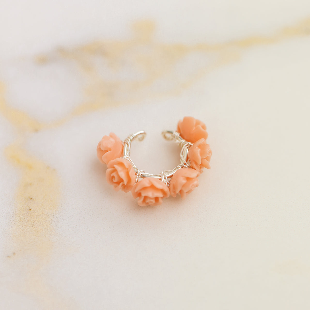 Peach coral resin rose conch ear cuff with dainty floral design and no piercing required