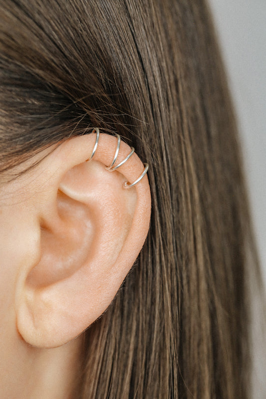 Handmade set of gold criss cross and double line helix ear cuffs for non-pierced ears, adjustable minimalist jewelry available in 12k gold filled, sterling silver, and 16 gauge black aluminum.