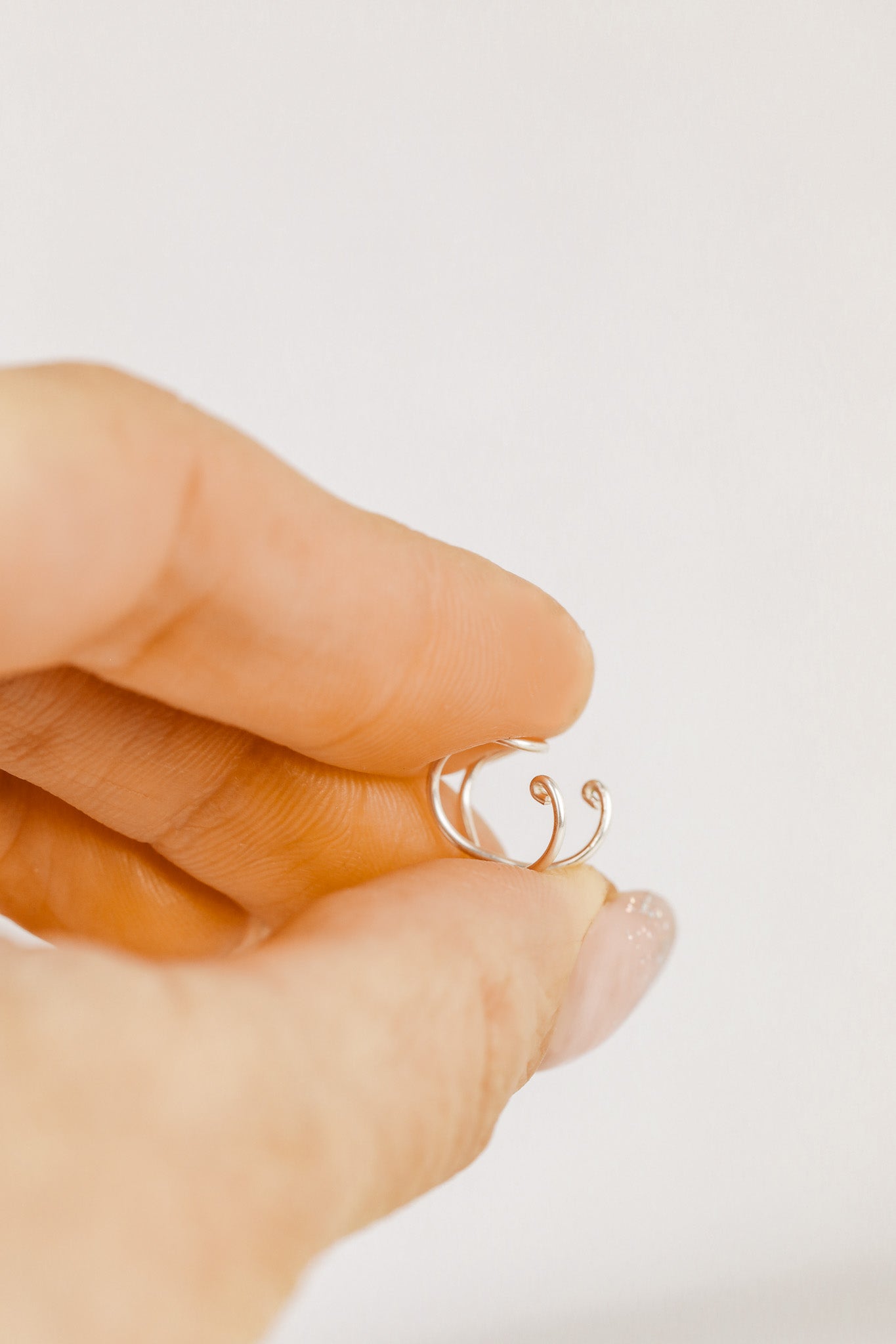 Handmade set of gold criss cross and double line helix ear cuffs for non-pierced ears, adjustable minimalist jewelry available in 12k gold filled, sterling silver, and 16 gauge black aluminum.