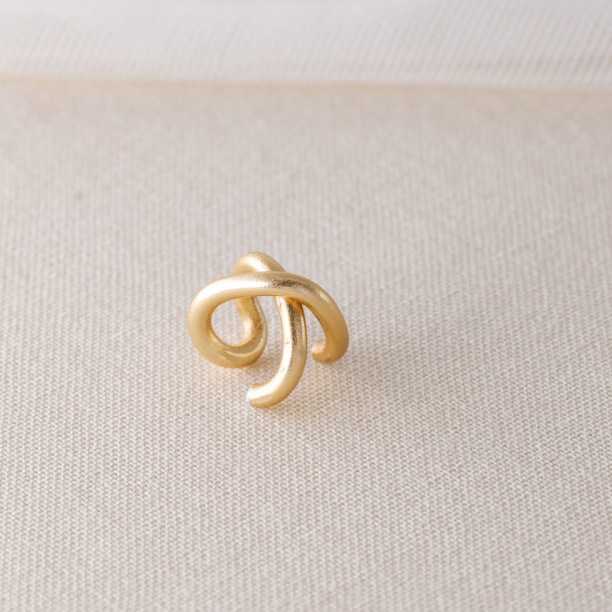 Adjustable no-piercing helix ear cuff shown worn on the upper cartilage area, available in silver, black and soft gold with Double Line and Criss-Cross style options for a bold stacked ear look.