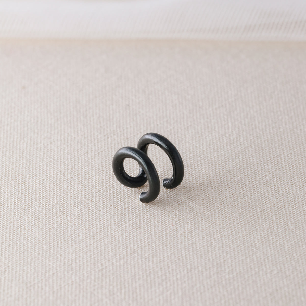 Adjustable no-piercing helix ear cuff shown worn on the upper cartilage area, available in silver, black and soft gold with Double Line and Criss-Cross style options for a bold stacked ear look.