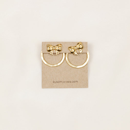 Pair of gold hammered round ear jackets displayed with decorative bow studs for a playful interchangeable earring combination.