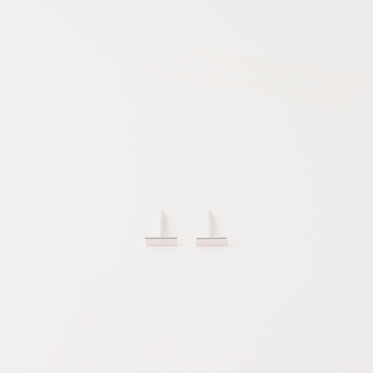 Tiny rectangle bar stud earrings in solid 925 sterling silver on white background
