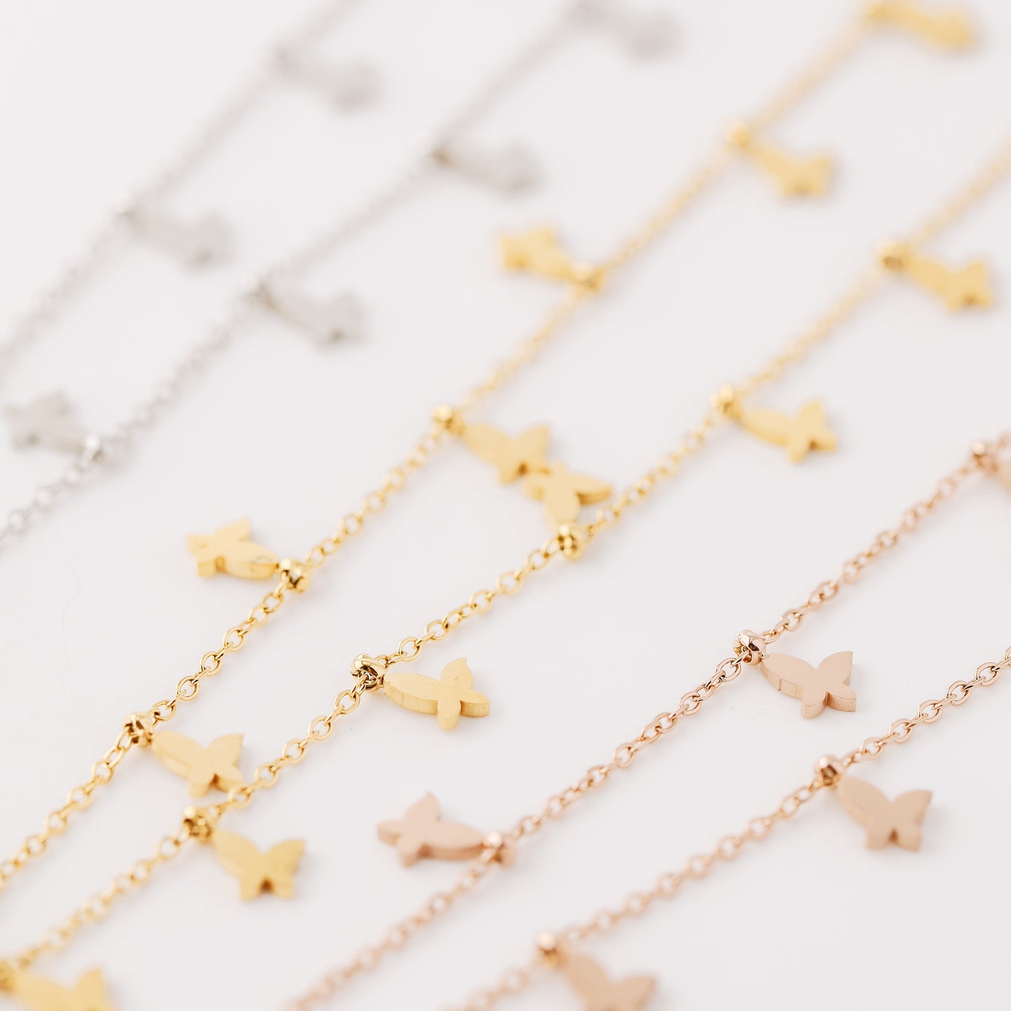 Indulge in the ethereal charm of our Butterflies Necklace! This dainty and minimal boho beaded necklace features delicate gold butterflies, creating a layered and feminine look. Perfect for adding a touch of bohemian flair to any outfit. Elevate your style with our Butterflies Necklace!