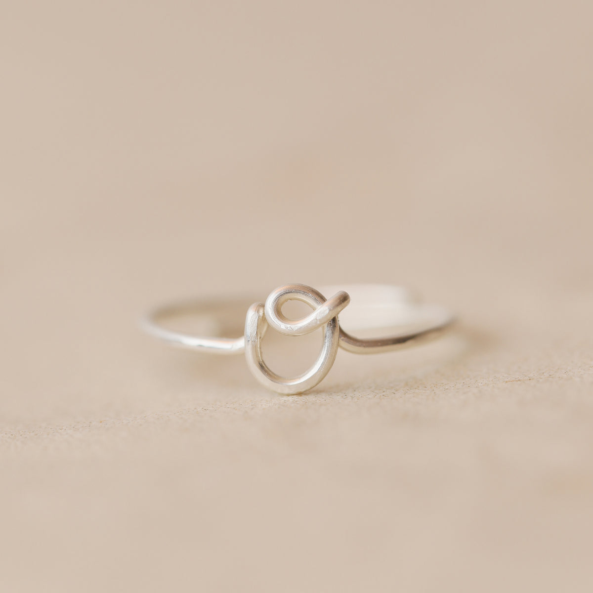 Handmade 925 sterling silver wire ring shaped into the letter O.