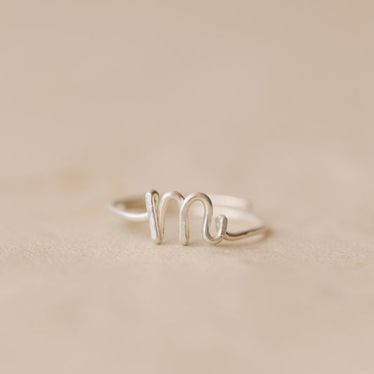 Handmade 925 sterling silver wire ring shaped into the letter M.