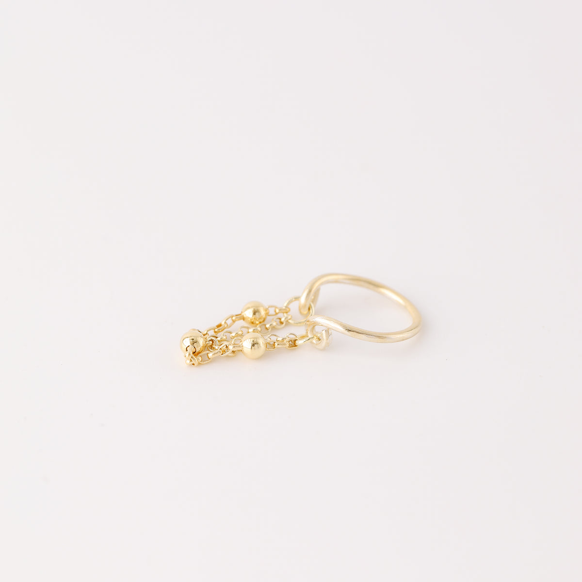 Gold beaded chain ear cuff worn on the conch with double draped chain detail