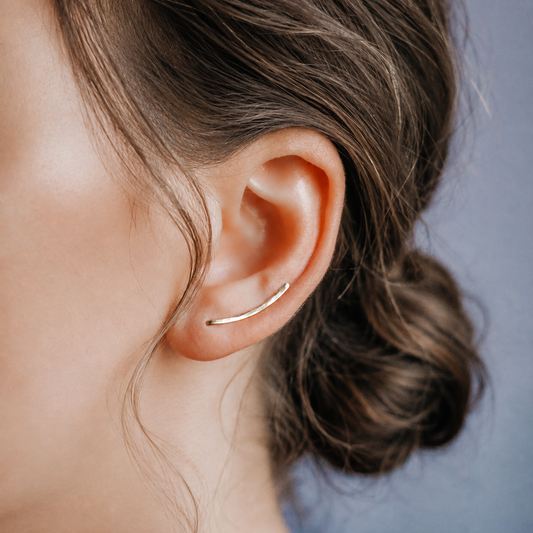 Handmade 20 mm minimalist ear climber earrings worn through one standard lobe piercing and rotated upward along the natural curve of the ear, featuring a small hand hammered wire design with a subtle close-to-ear sweep shape, available as a single left ear climber, single right ear climber or pair in solid 925 sterling silver, 14k gold filled and 14k rose gold filled, with length options from 10mm to 50mm.