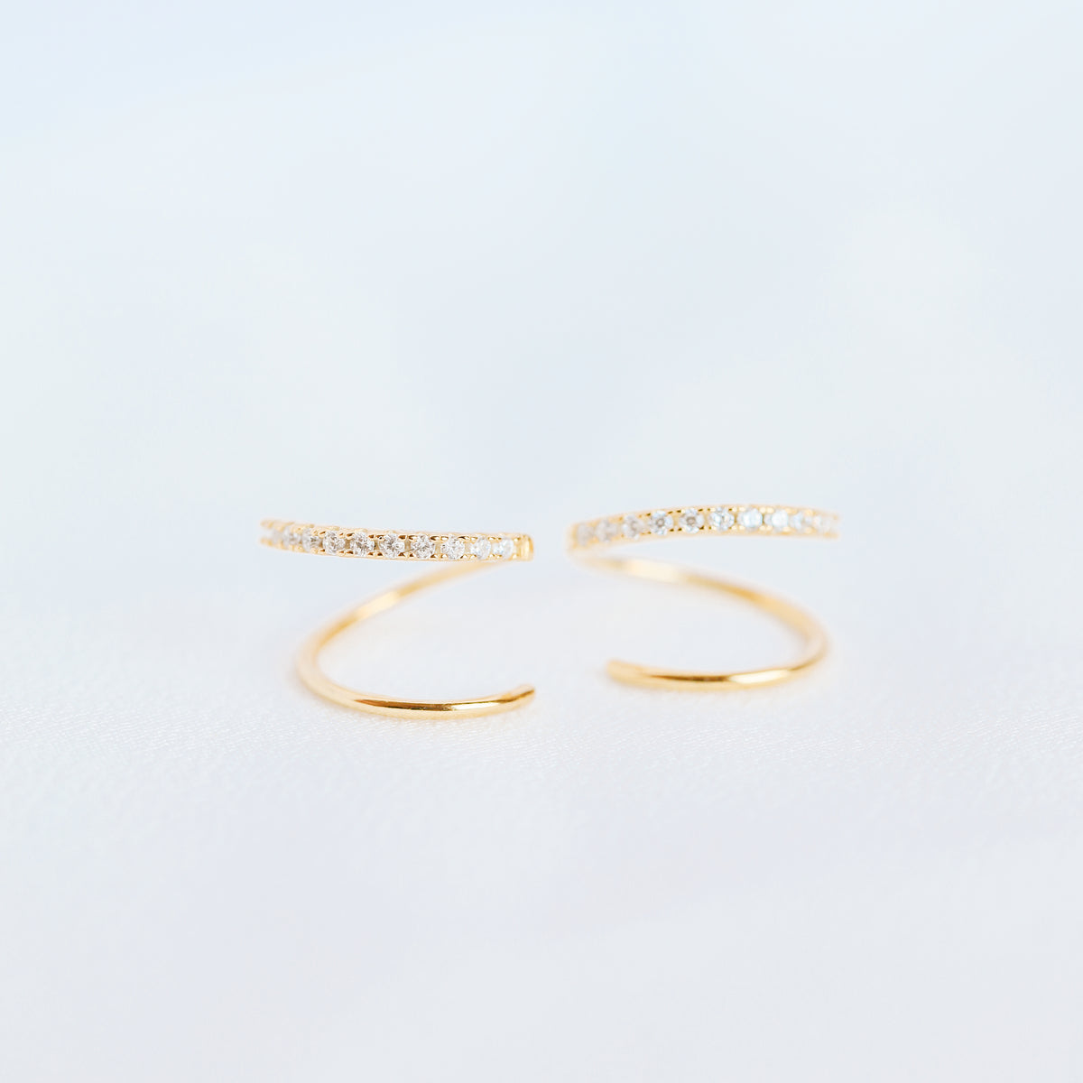Lightweight gold twist hoop earring worn on ear