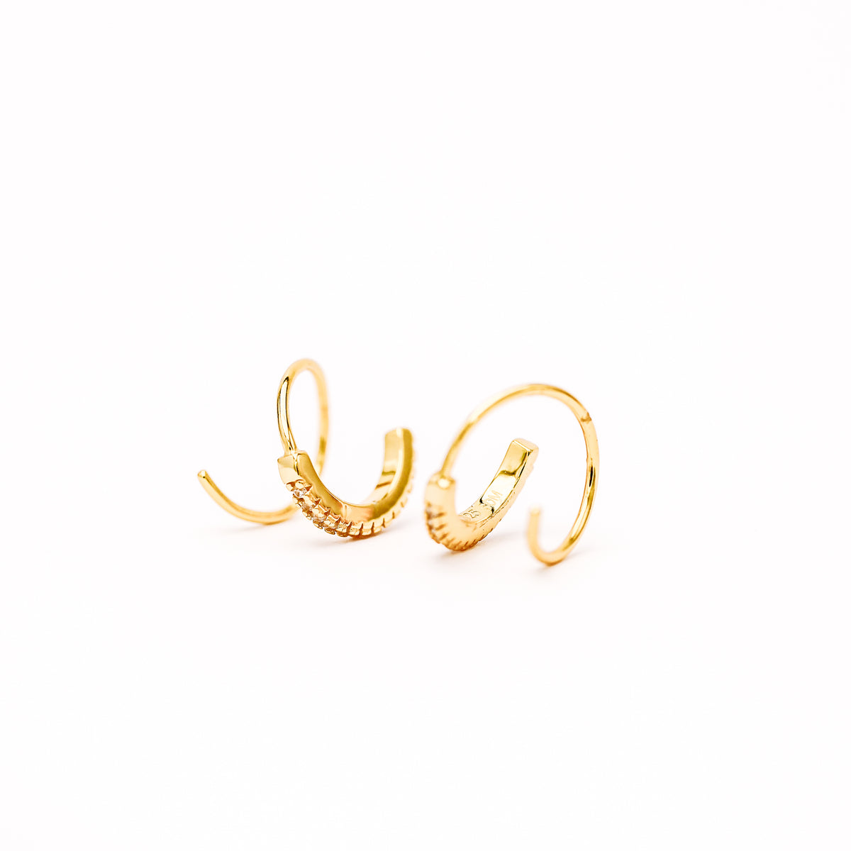 Lightweight gold twist hoop earring worn on ear