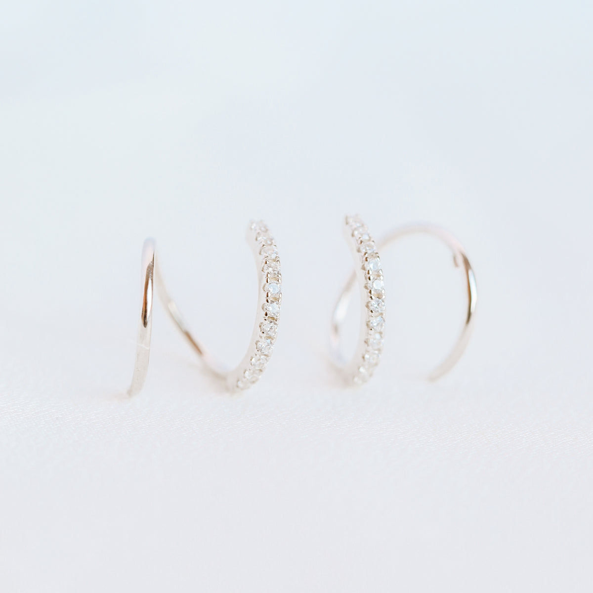 Lightweight gold twist hoop earring worn on ear
