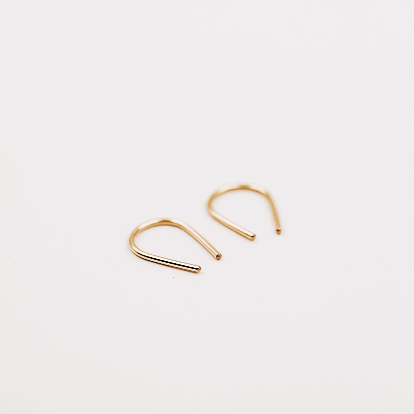 Gold filled U shape earrings displayed on white background