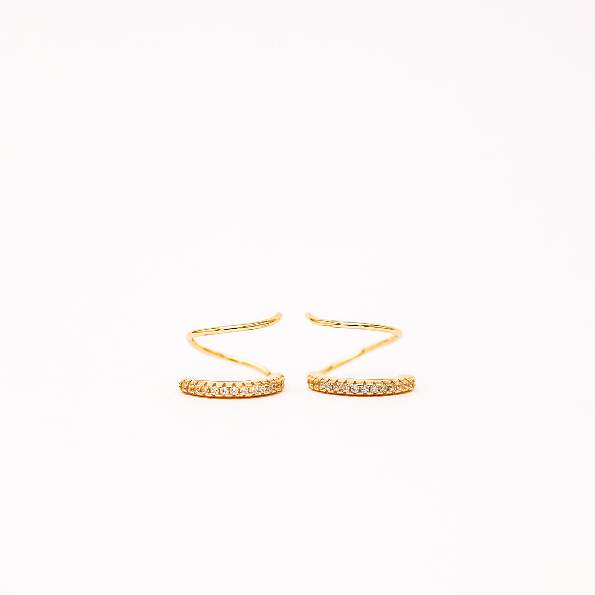 Lightweight gold twist hoop earring worn on ear