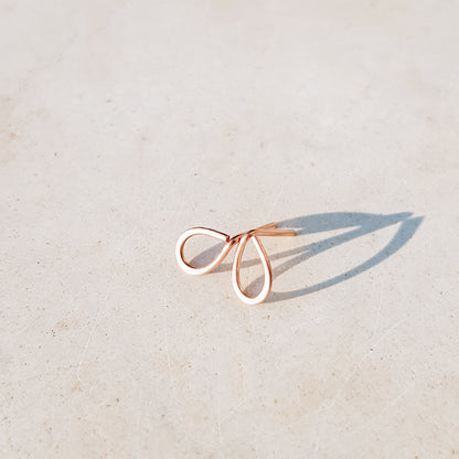 Minimal open drop stud earrings in gold filled sterling silver on neutral background with soft natural light