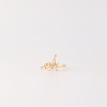 Dainty handmade gold wire ring with an uppercase cursive letter A.