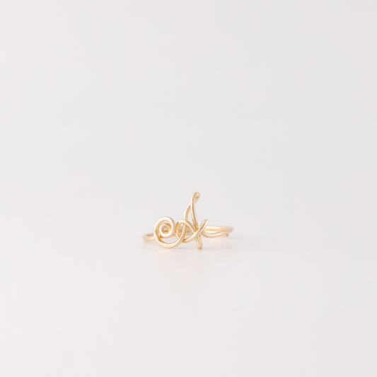 Dainty handmade gold wire ring with an uppercase cursive letter A.