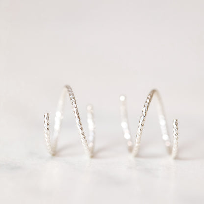 Minimal silver double hoop earrings on ear, tiny spiral earrings, sterling silver illusion double piercing jewelry