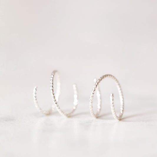 Minimal silver double hoop earrings on ear, tiny spiral earrings, sterling silver illusion double piercing jewelry