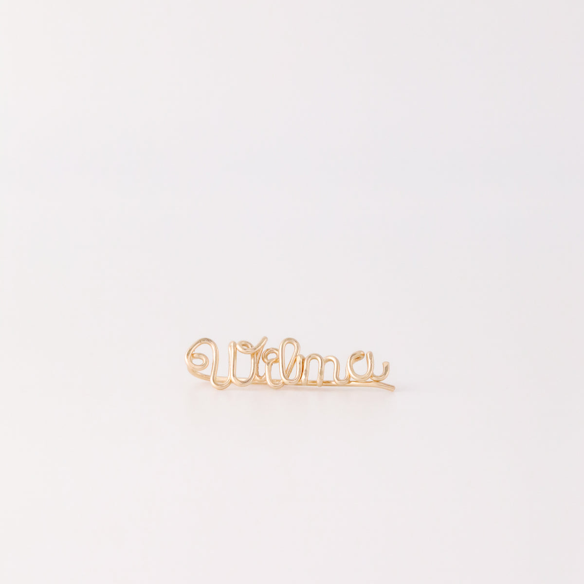 Handmade personalized name ear climber worn across the lobe through one standard piercing, featuring a custom flowing wire script design made with the chosen name or word up to 10 characters, available as a single left ear climber, single right ear climber or pair in solid 925 sterling silver, 14k gold filled and 14k rose gold filled.
