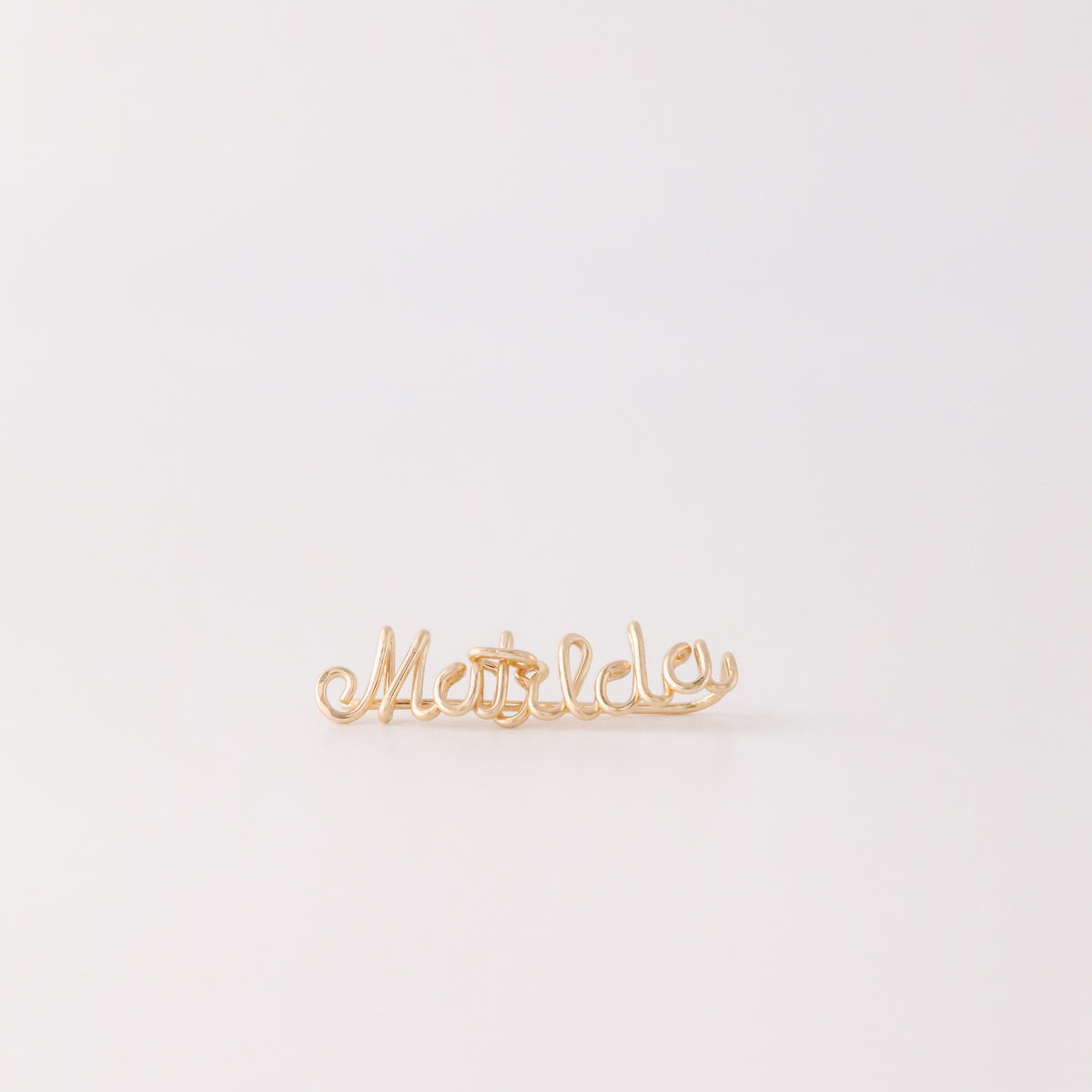 Handmade personalized name ear climber worn across the lobe through one standard piercing, featuring a custom flowing wire script design made with the chosen name or word up to 10 characters, available as a single left ear climber, single right ear climber or pair in solid 925 sterling silver, 14k gold filled and 14k rose gold filled.
