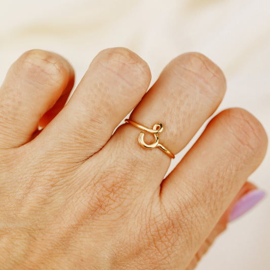 Dainty handmade gold wire ring featuring a lowercase cursive letter S.