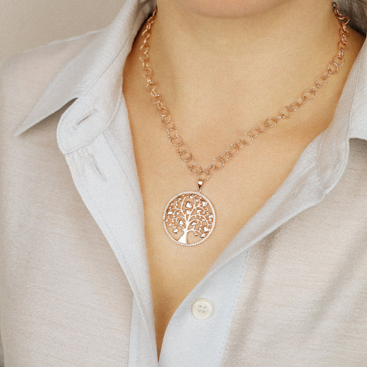 Indulge in luxury with our Tree of Life with Hearts Necklace. Crafted in rose gold, this delicate pendant features a dazzling pave tree of life design, symbolizing family and love. Perfect for Mother's Day, this necklace is a heartfelt gift that will be cherished for years to come.