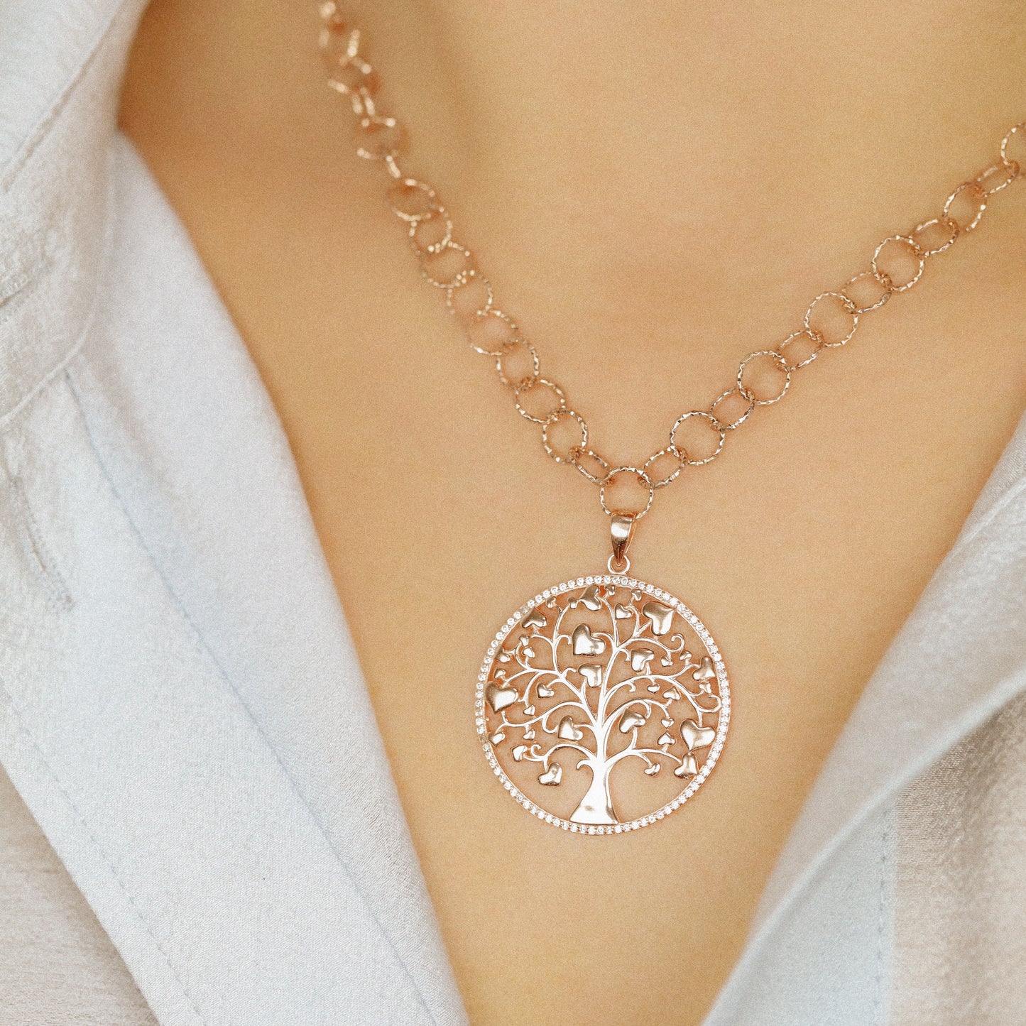 Indulge in luxury with our Tree of Life with Hearts Necklace. Crafted in rose gold, this delicate pendant features a dazzling pave tree of life design, symbolizing family and love. Perfect for Mother's Day, this necklace is a heartfelt gift that will be cherished for years to come.