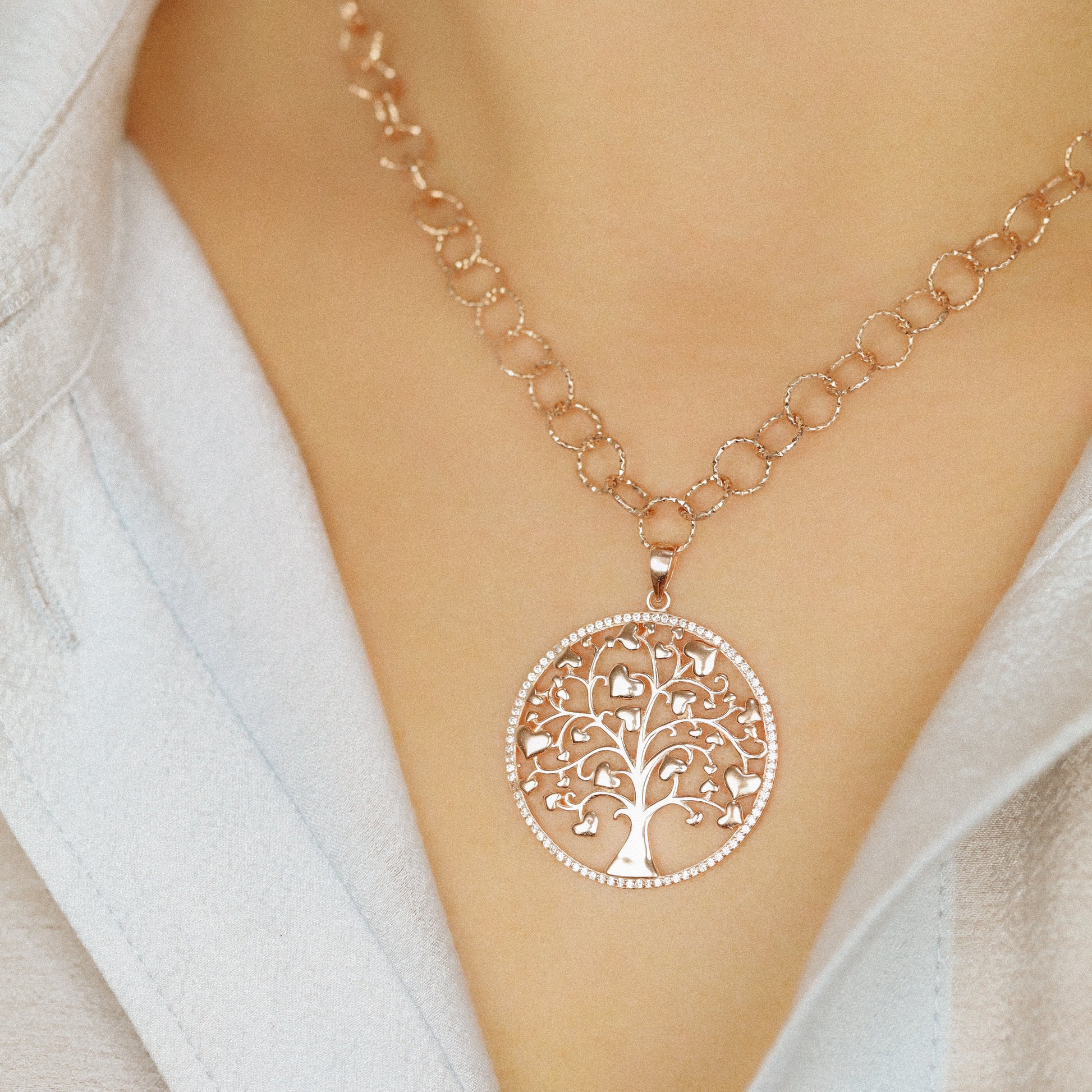 Indulge in luxury with our Tree of Life with Hearts Necklace. Crafted in rose gold, this delicate pendant features a dazzling pave tree of life design, symbolizing family and love. Perfect for Mother's Day, this necklace is a heartfelt gift that will be cherished for years to come.