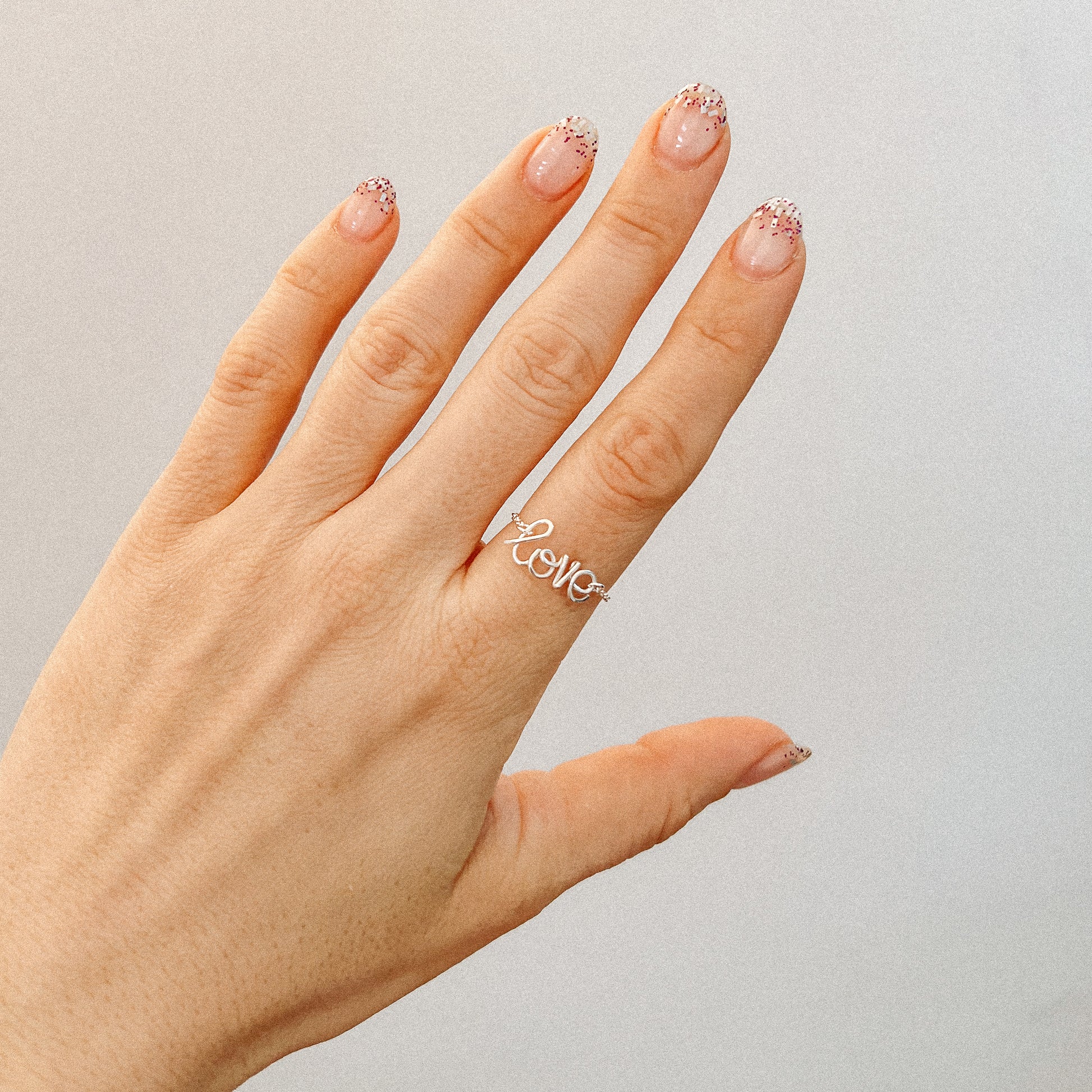 Handmade silver name ring with delicate chain detailer 