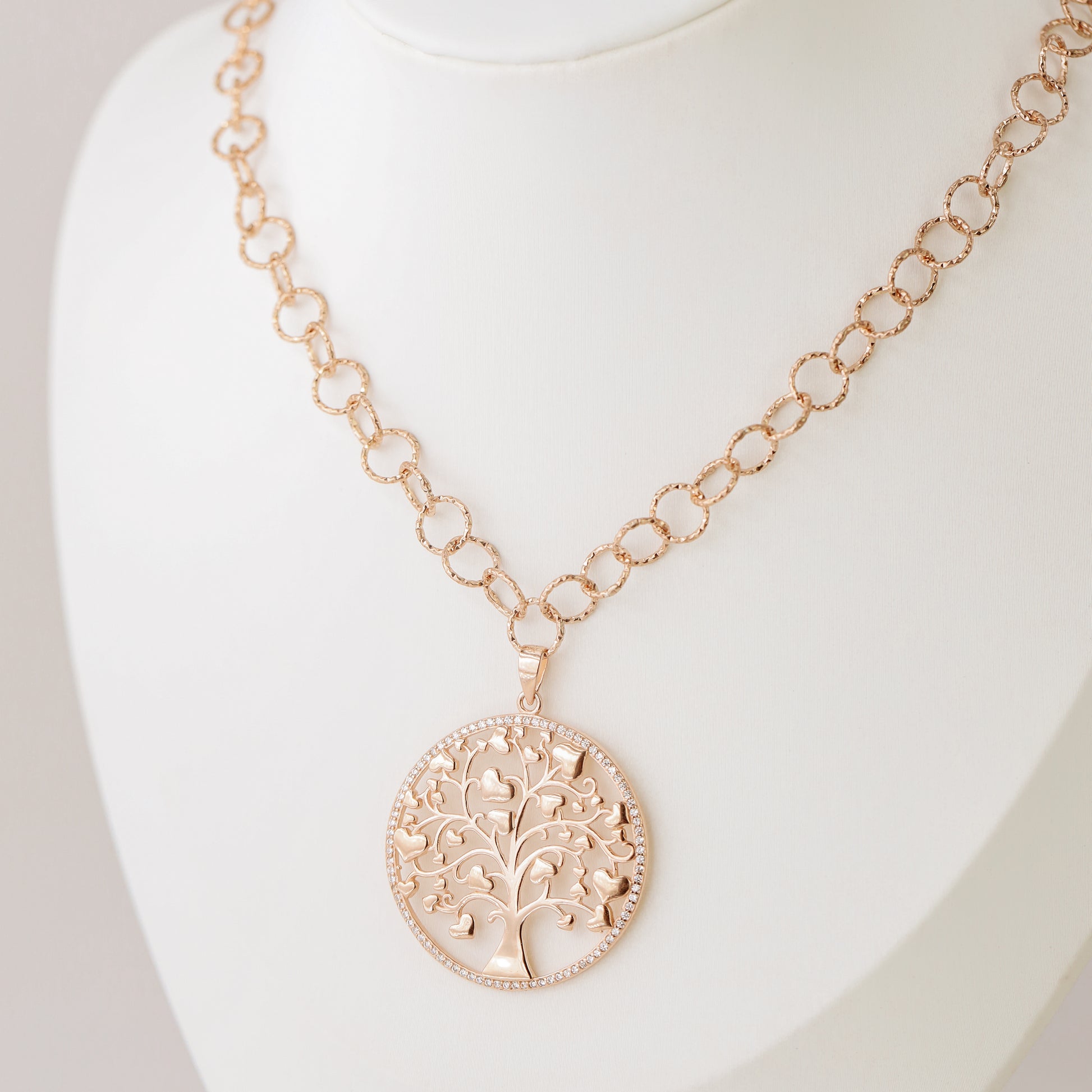 Indulge in luxury with our Tree of Life with Hearts Necklace. Crafted in rose gold, this delicate pendant features a dazzling pave tree of life design, symbolizing family and love. Perfect for Mother's Day, this necklace is a heartfelt gift that will be cherished for years to come.
