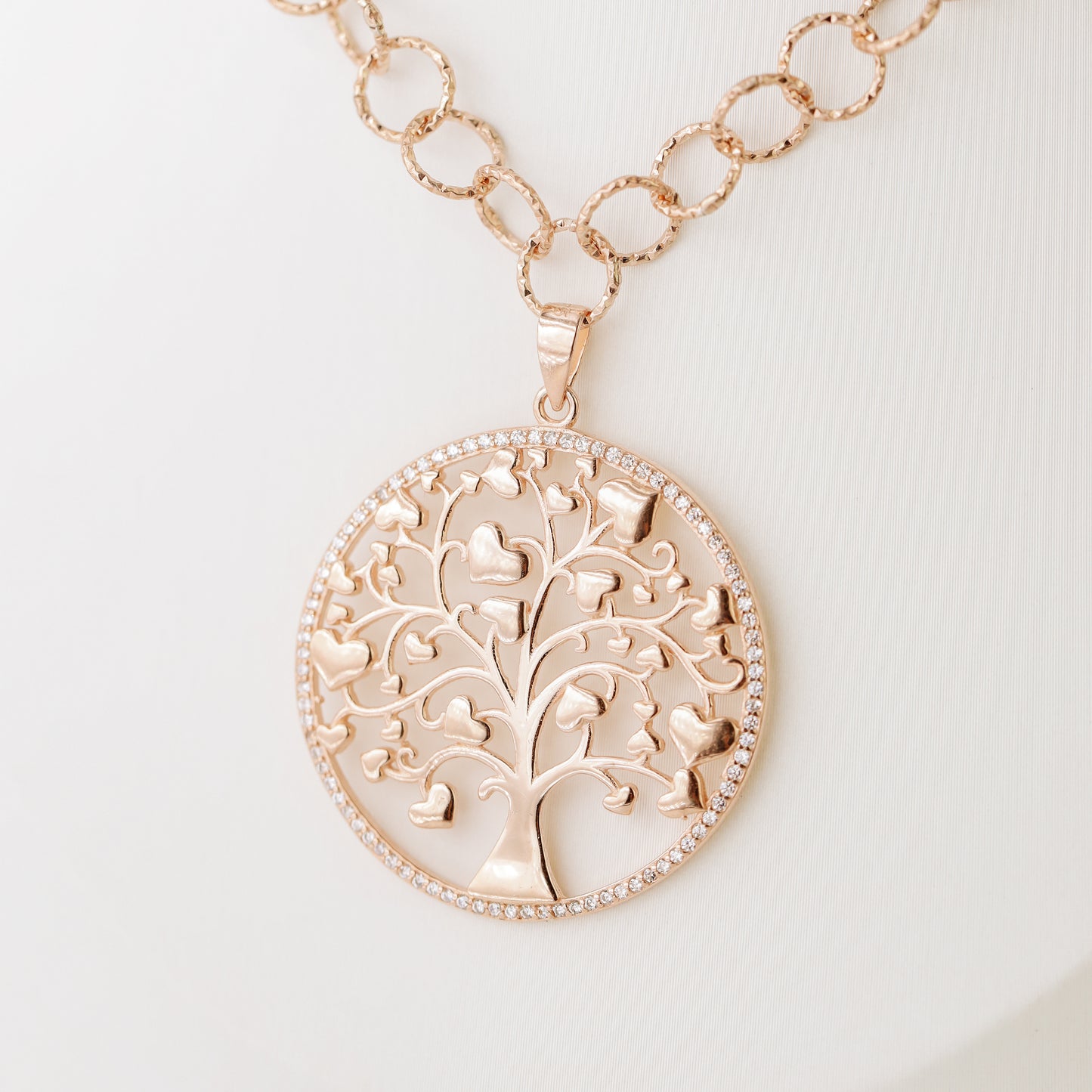 Indulge in luxury with our Tree of Life with Hearts Necklace. Crafted in rose gold, this delicate pendant features a dazzling pave tree of life design, symbolizing family and love. Perfect for Mother's Day, this necklace is a heartfelt gift that will be cherished for years to come.