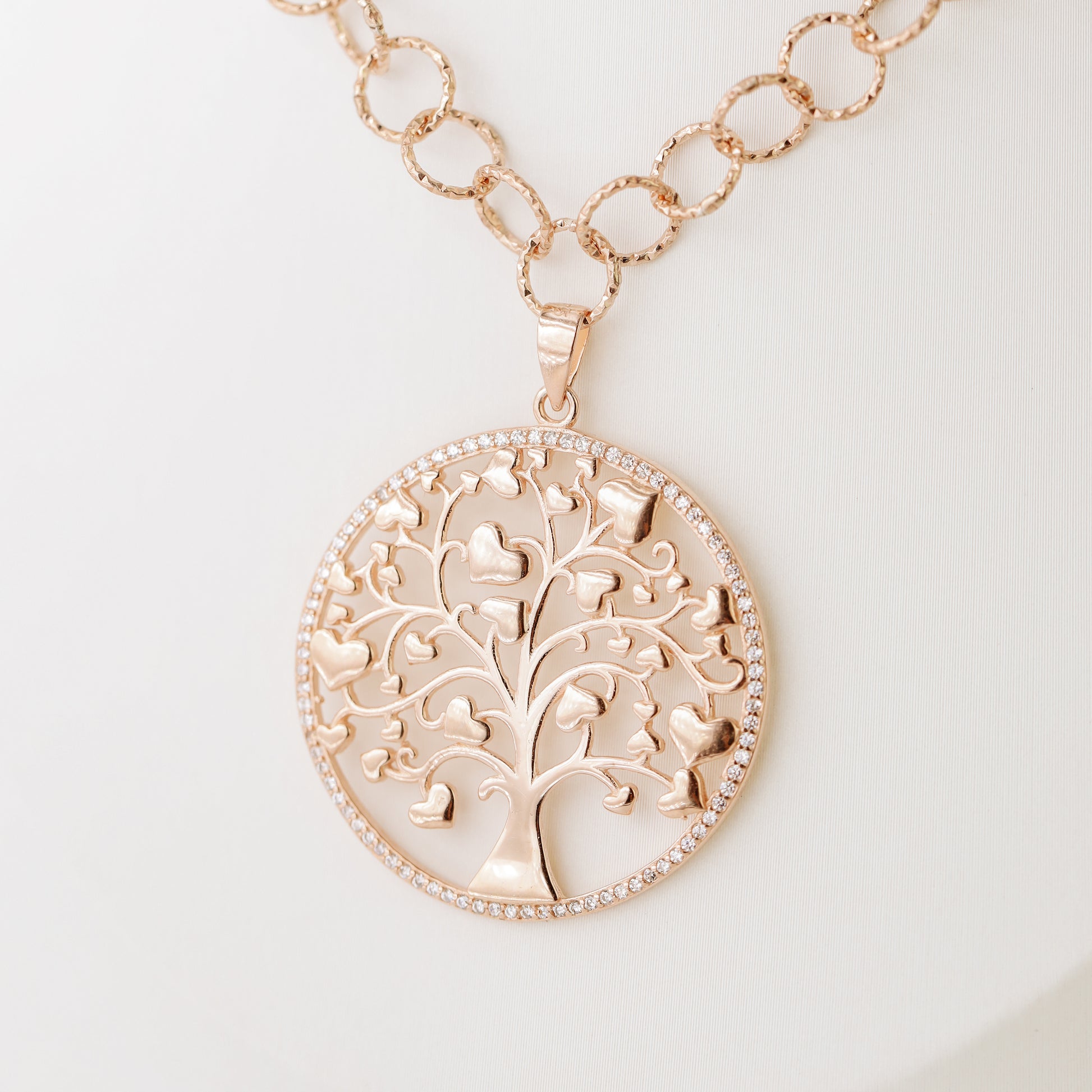 Indulge in luxury with our Tree of Life with Hearts Necklace. Crafted in rose gold, this delicate pendant features a dazzling pave tree of life design, symbolizing family and love. Perfect for Mother's Day, this necklace is a heartfelt gift that will be cherished for years to come.