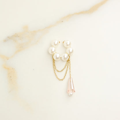 Dainty pearl crystal conch ear cuff shown as a no-piercing cartilage accessory, featuring artificial pearls around the conch area, delicate draped chains and a dangling faceted crystal drop, handmade and available in sterling silver 925, 14k gold filled or 14k rose gold filled.