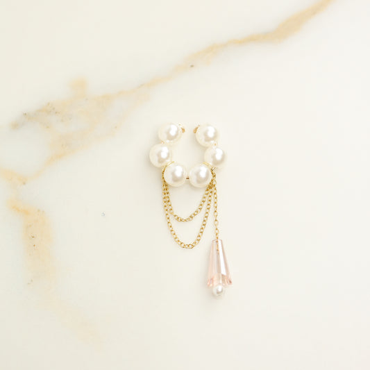 Dainty pearl crystal conch ear cuff shown as a no-piercing cartilage accessory, featuring artificial pearls around the conch area, delicate draped chains and a dangling faceted crystal drop, handmade and available in sterling silver 925, 14k gold filled or 14k rose gold filled.