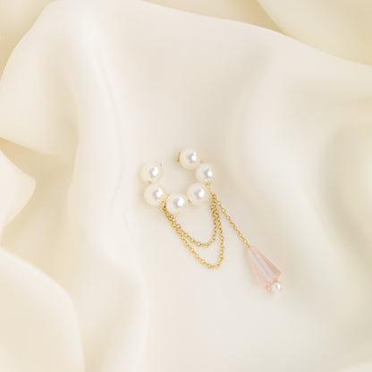 Dainty pearl crystal conch ear cuff shown as a no-piercing cartilage accessory, featuring artificial pearls around the conch area, delicate draped chains and a dangling faceted crystal drop, handmade and available in sterling silver 925, 14k gold filled or 14k rose gold filled.