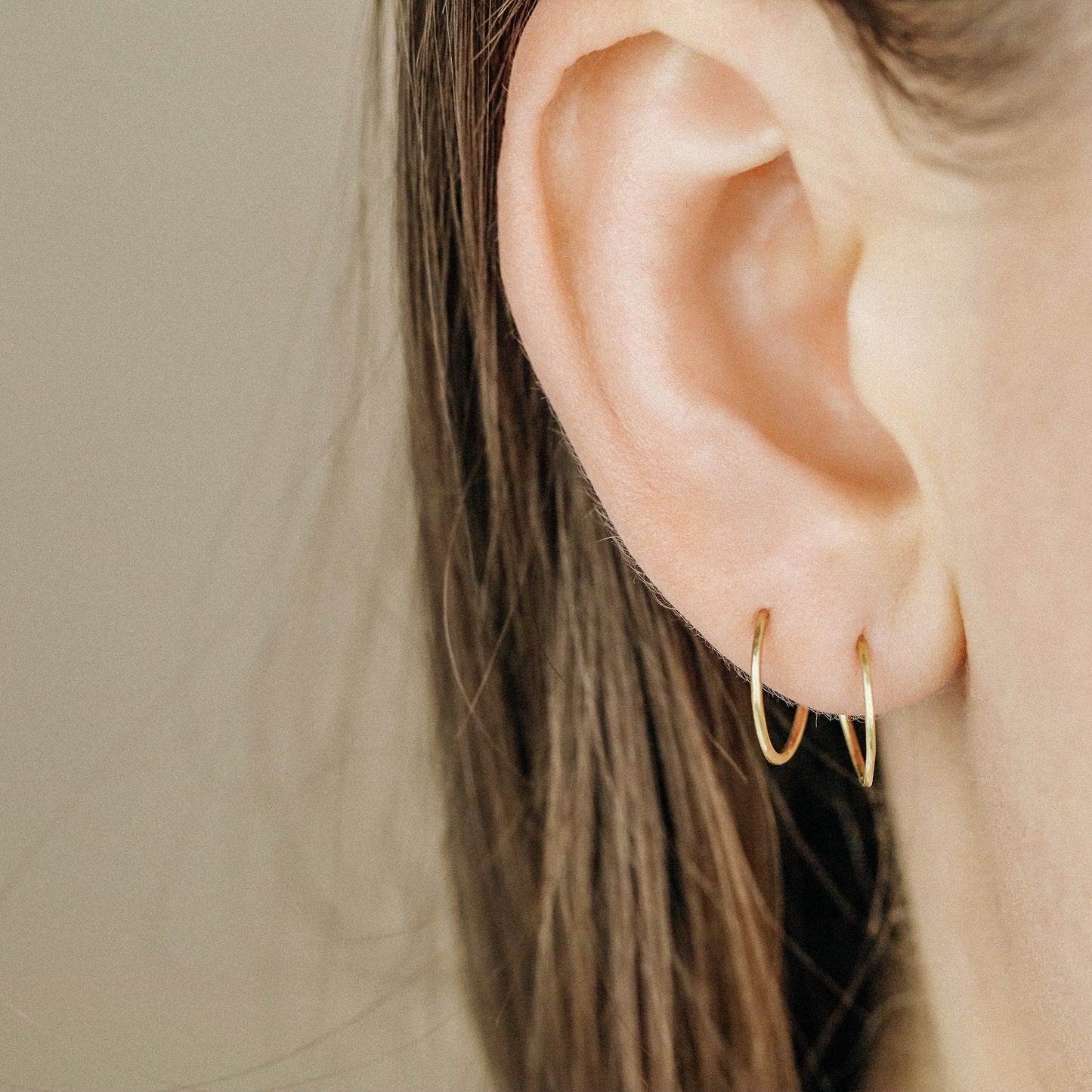 Detailed view of a handmade 12k gold filled hoop earring featuring a secure loop-and-hook closure, minimalist design for lobe and cartilage piercings.