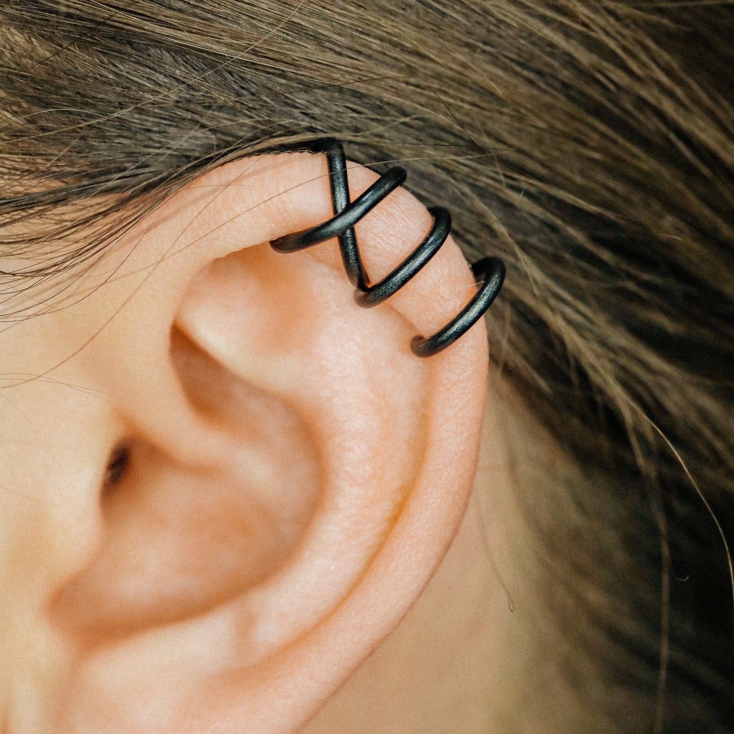 No-piercing double line and criss cross helix ear cuff shown on the upper ear, with smooth and diamond cut finish options for cartilage styling.