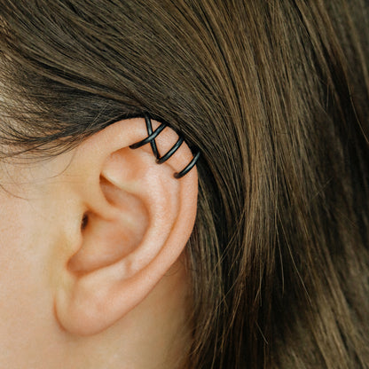 No-piercing double line and criss cross helix ear cuff shown on the upper ear, with smooth and diamond cut finish options for cartilage styling.
