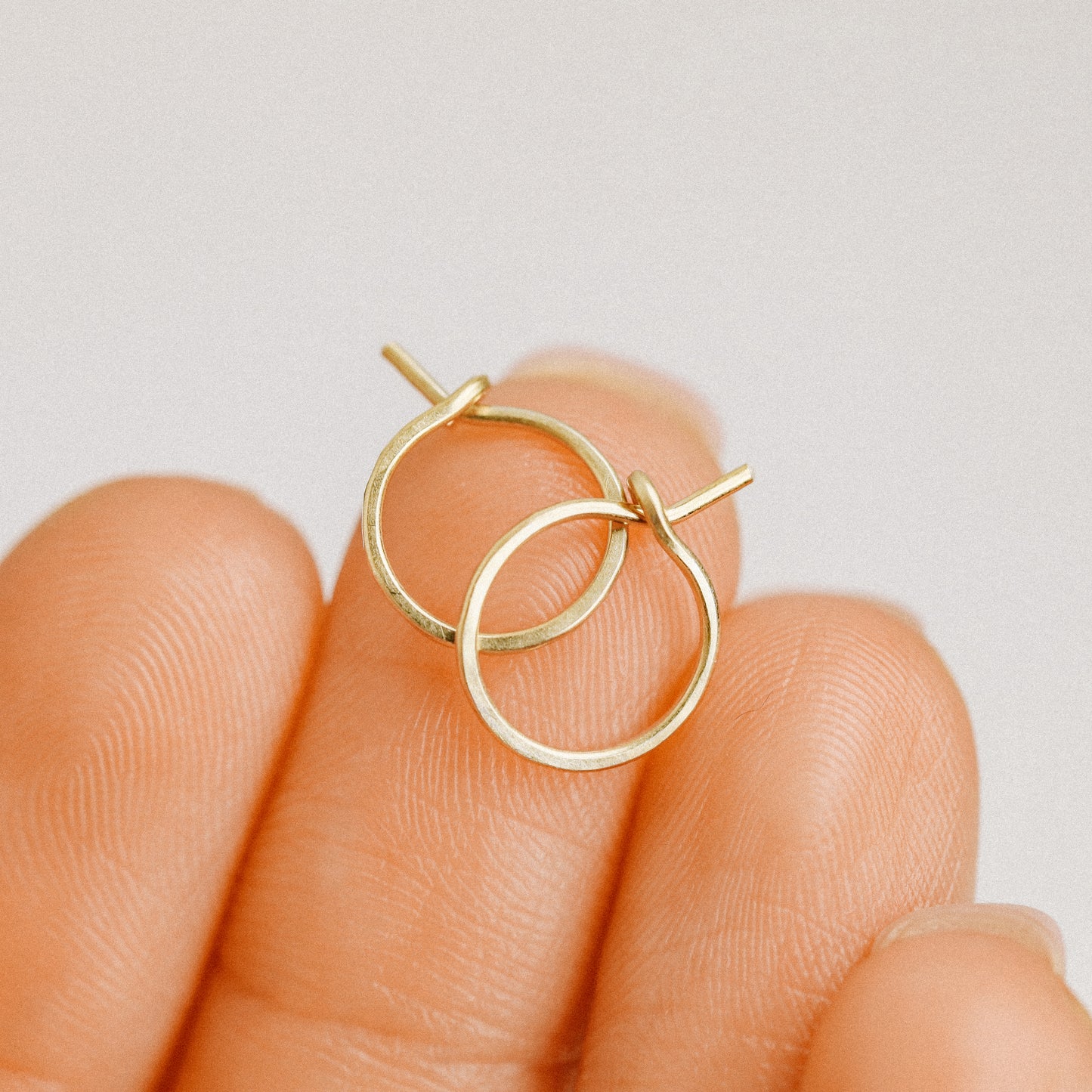 Detailed view of a handmade 12k gold filled hoop earring featuring a secure loop-and-hook closure, minimalist design for lobe and cartilage piercings.