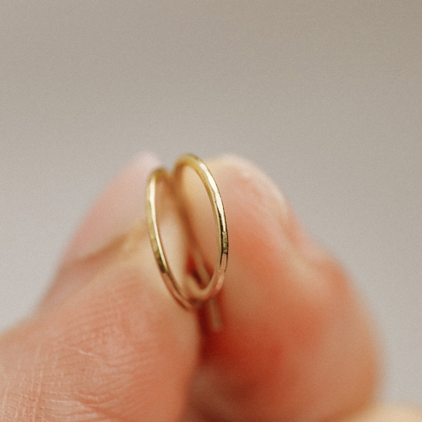 Detailed view of a handmade 12k gold filled hoop earring featuring a secure loop-and-hook closure, minimalist design for lobe and cartilage piercings.