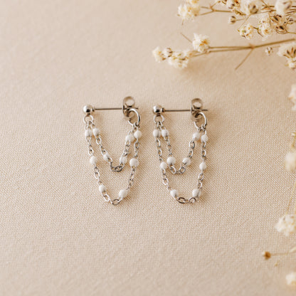 Silver chain dangle earrings with tiny white enamel beads and stud post closure