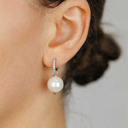 Pearl drop hoop earring worn on brunette model showing the small crystal hoop and round pearl drop