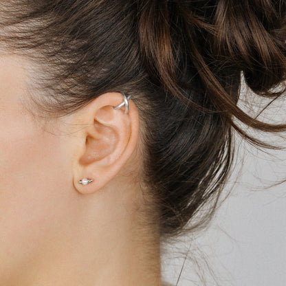 Adjustable no-piercing helix ear cuff shown worn on the upper cartilage area, available in silver, black and soft gold with Double Line and Criss-Cross style options for a bold stacked ear look.