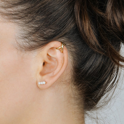 Adjustable no-piercing helix ear cuff shown worn on the upper cartilage area, available in silver, black and soft gold with Double Line and Criss-Cross style options for a bold stacked ear look.