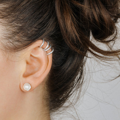 Adjustable no-piercing helix ear cuff shown worn on the upper cartilage area, available in silver, black and soft gold with Double Line and Criss-Cross style options for a bold stacked ear look.