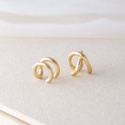 Adjustable no-piercing helix ear cuff shown worn on the upper cartilage area, available in silver, black and soft gold with Double Line and Criss-Cross style options for a bold stacked ear look.