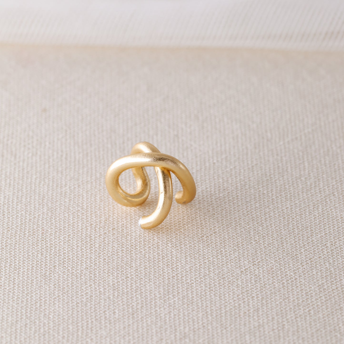 Adjustable no-piercing helix ear cuff shown worn on the upper cartilage area, available in silver, black and soft gold with Double Line and Criss-Cross style options for a bold stacked ear look.