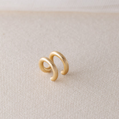 Adjustable no-piercing helix ear cuff shown worn on the upper cartilage area, available in silver, black and soft gold with Double Line and Criss-Cross style options for a bold stacked ear look.