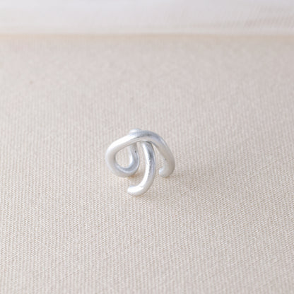 Adjustable no-piercing helix ear cuff shown worn on the upper cartilage area, available in silver, black and soft gold with Double Line and Criss-Cross style options for a bold stacked ear look.